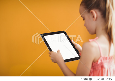 Rear view of girl using a tablet 32301745