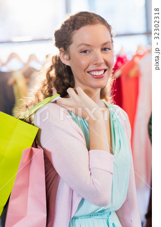 Woman wearing shopping bags Woman wearing shopping bags 32302318