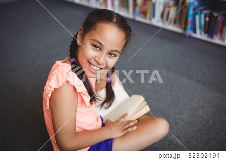 Little girl reading a book Little girl reading a book 32302494