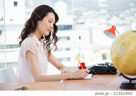 Hipster woman writing on her notebook Hipster woman writing on her notebook 32302892