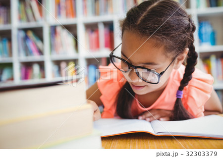 Little girl reading a book Little girl reading a book 32303379