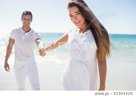 Pretty woman holding the hand of her boyfriend Pretty woman holding the hand of her boyfriend 32303420