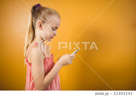 Girl with a ponytail with a smartphone Girl with a ponytail with a smartphone 32303542
