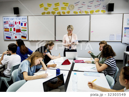 Group of diverse high school students studying in class 32303549