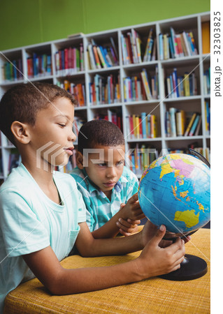 Boys studying the globe Boys studying the globe 32303825