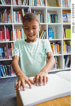 Boy using braille to read 32303928