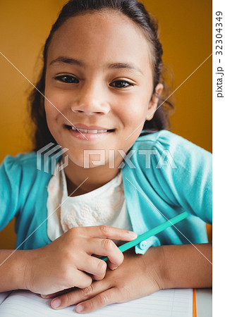 Girl sitting at a desk Girl sitting at a desk 32304349