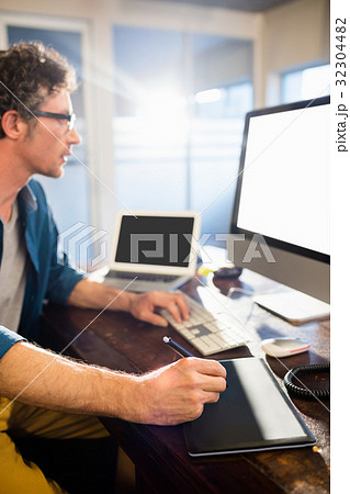 Businessman using a graphic pad Businessman using a graphic pad 32304482