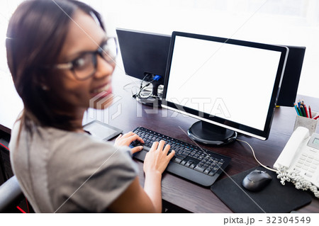 Casual businesswoman working on laptop Casual businesswoman working on laptop 32304549