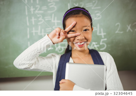 Cute schoolgirl doing the peace sign Cute schoolgirl doing the peace sign 32304645
