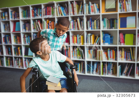 Little boys holding books 32305673