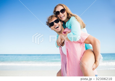 Happy couple posing on the beach 32306210