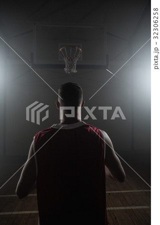 Portrait of basketball player front the back in front of a basket 32306258