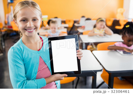 portrait of smiling pupil standing with tablet pc portrait of smiling pupil standing with tablet pc 32306461