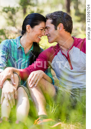 Couple sitting and holding each other 32306704