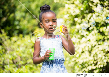 Little girl making bubble at park 32306707