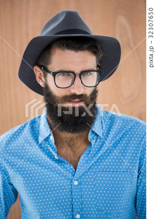 Hipster wearing glasses and hat Hipster wearing glasses and hat 32307650