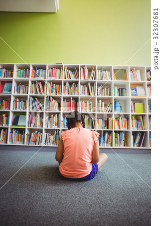 Little girl reading a book 32307681