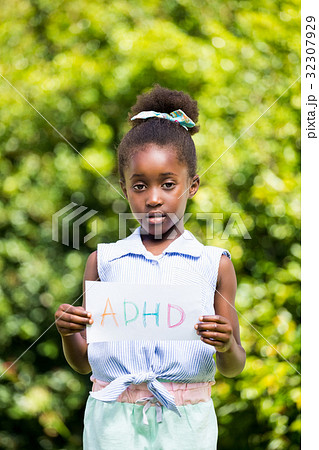 Cute mixed-race girl holding a paper with a message Cute mixed-race girl holding a paper with a message 32307929