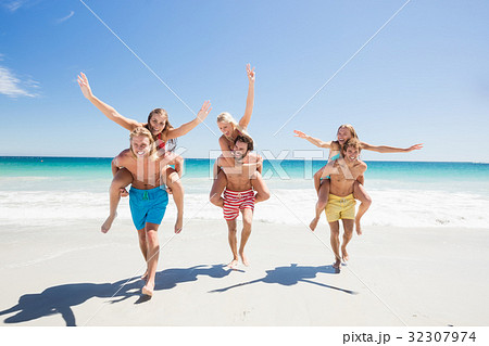 Friends having fun at the beach 32307974
