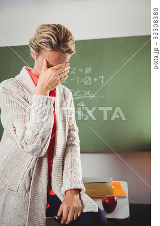 Teacher crying in front of blackboard Teacher crying in front of blackboard 32308380