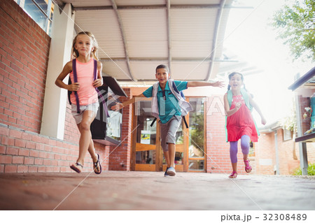 Three kids running in the playground 32308489