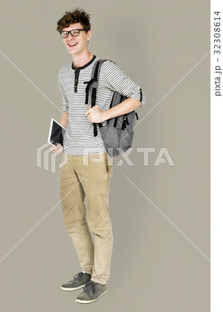 Caucasian young man standing with backpack and tablet Caucasian young man standing with backpack and tablet 32308614