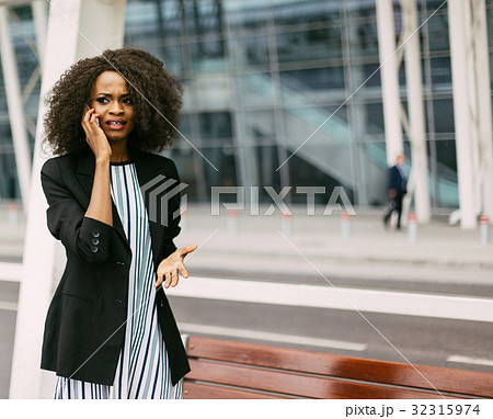 Beautiful afro-american girl is upset while Beautiful afro-american girl is upset while 32315974