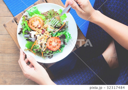 Woman in yoga clothing eating salad, Healthy Woman in yoga clothing eating salad, Healthy 32317484