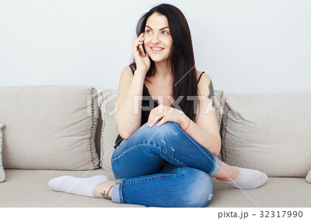Woman reading on her mobile phone and smiling 32317990