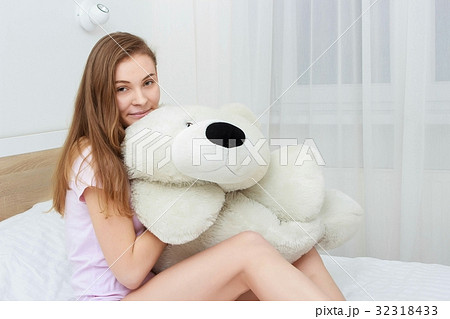 Beautiful teenager hugging soft teddy bear and 32318433
