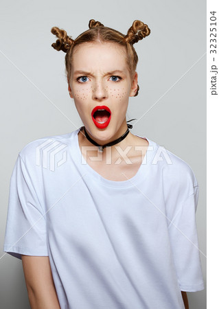 Funny girl with painted freckles looking surprised 32325104