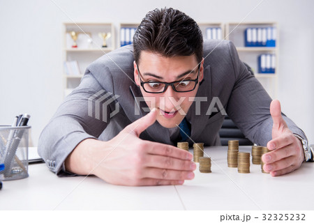 Businessman with golden coins in business growth 32325232