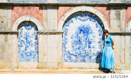 tourist near outside wall of Estoi Palace 32325264