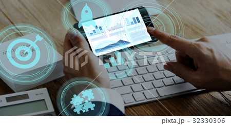 Hands working on digital device network graphic overlay 32330306