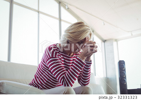 Depressed businesswoman sitting on sofa Depressed businesswoman sitting on sofa 32331323