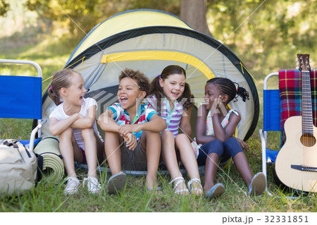 Happy friends sitting in tent 32331851