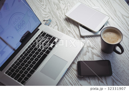 Various technologies with coffee cup on table in office Various technologies with coffee cup on table in office 32331907