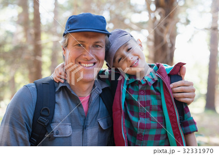 Portrait of happy father and son with arm around Portrait of happy father and son with arm around 32331970