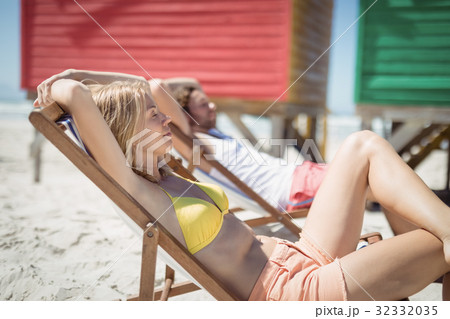 Young woman relaxaing on lounge chair at beach 32332035