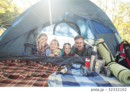Smiling family lying in the tent 32332102