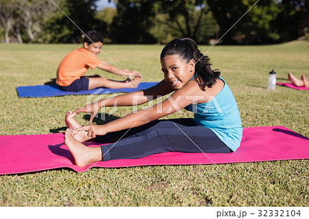 Portrait of girl touching toes during yoga glass 32332104