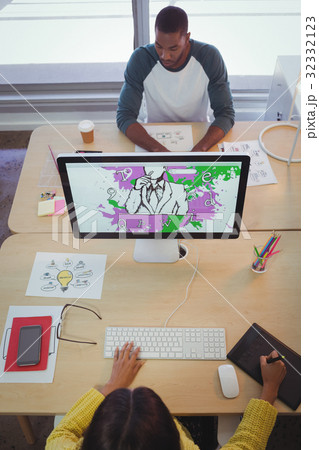 Male and female designer working in creative office 32332123