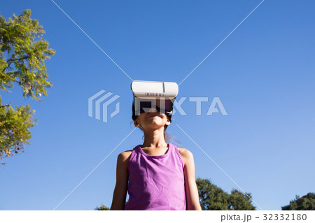 Girl using vr headset in the park Girl using vr headset in the park 32332180