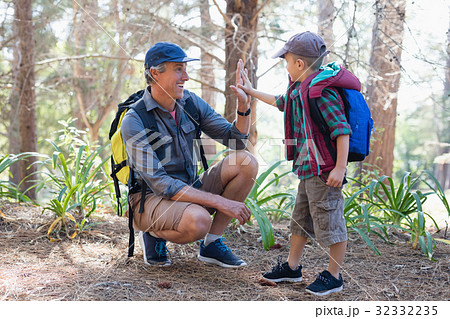 Boy giving high five to father Boy giving high five to father 32332235