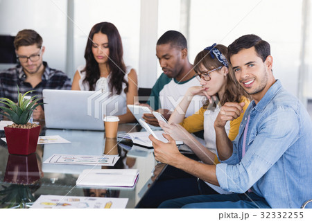 Portrait of creative businessman with team working at office Portrait of creative businessman with team working at office 32332255