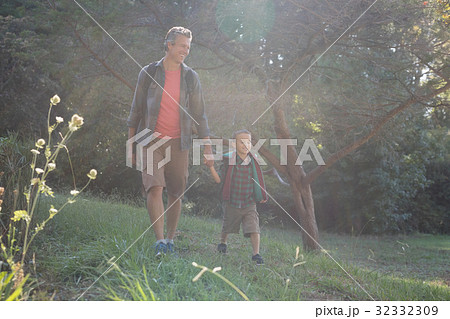 Happy father and son hiking on grass Happy father and son hiking on grass 32332309