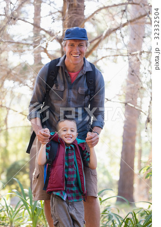 Portrait of playful father and son in forest 32332504