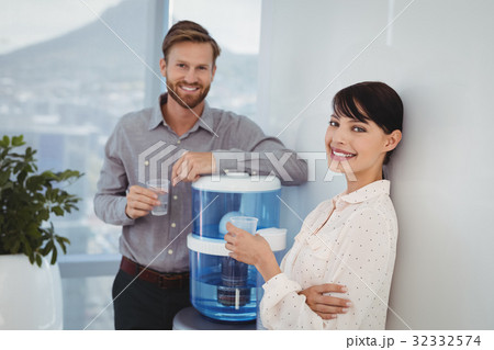 Portrait of smiling executives holding glasses of water 32332574