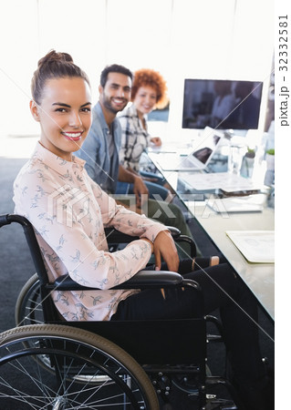 Portrait of smiling businesswoman sitting on wheelchair 32332581